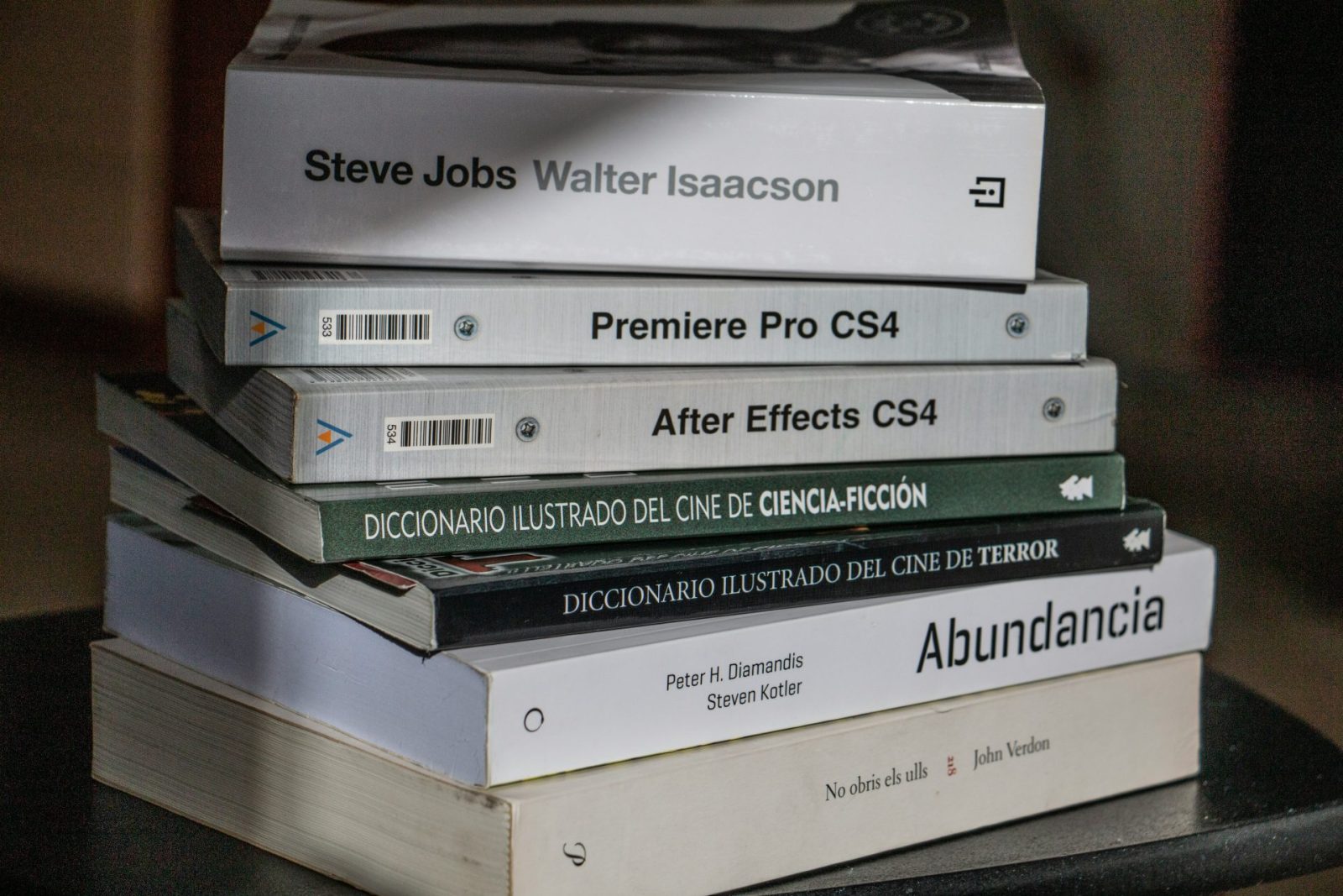 a stack of books sitting on top of a table