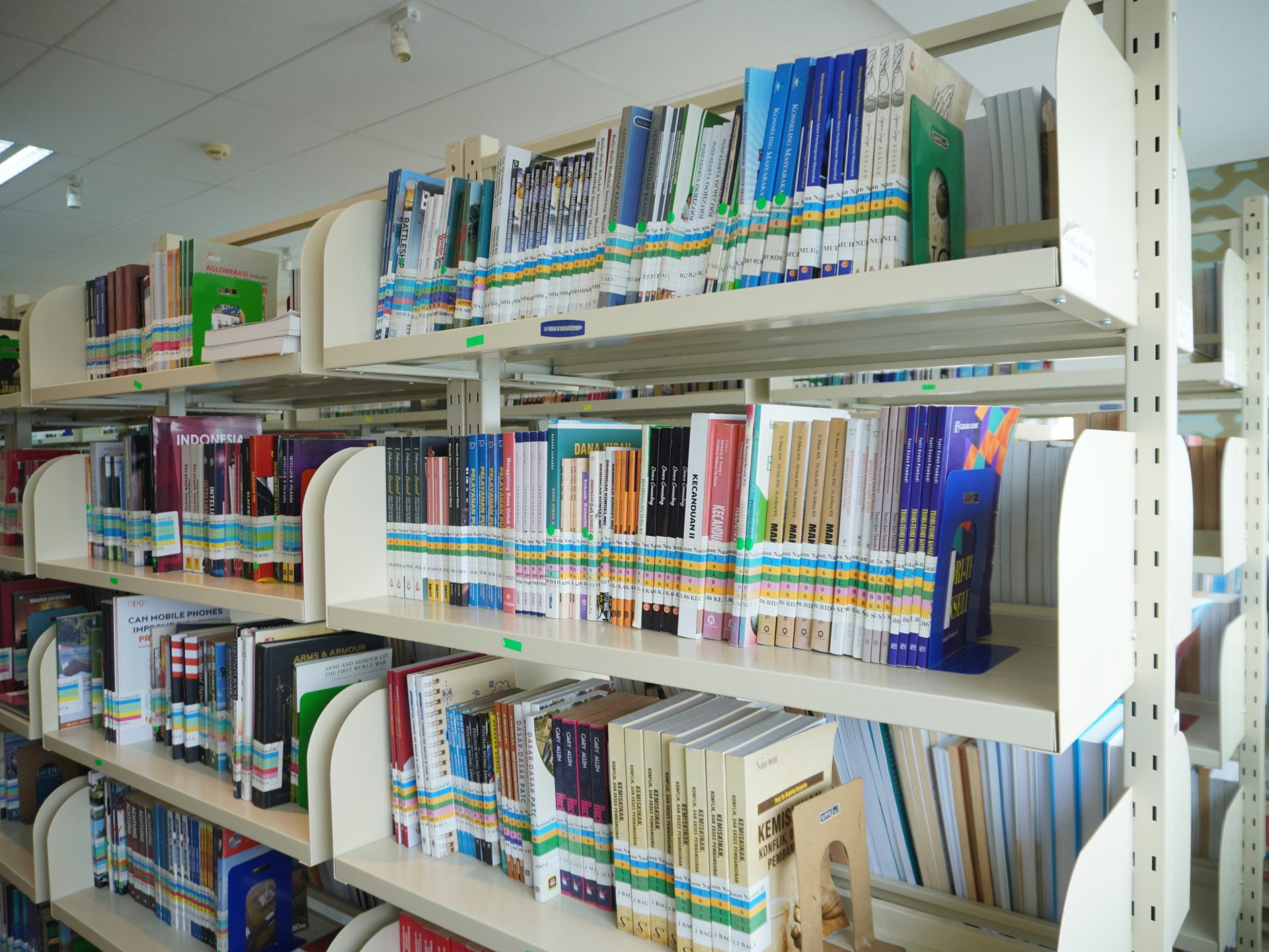 A bookshelf filled with lots of books in a library